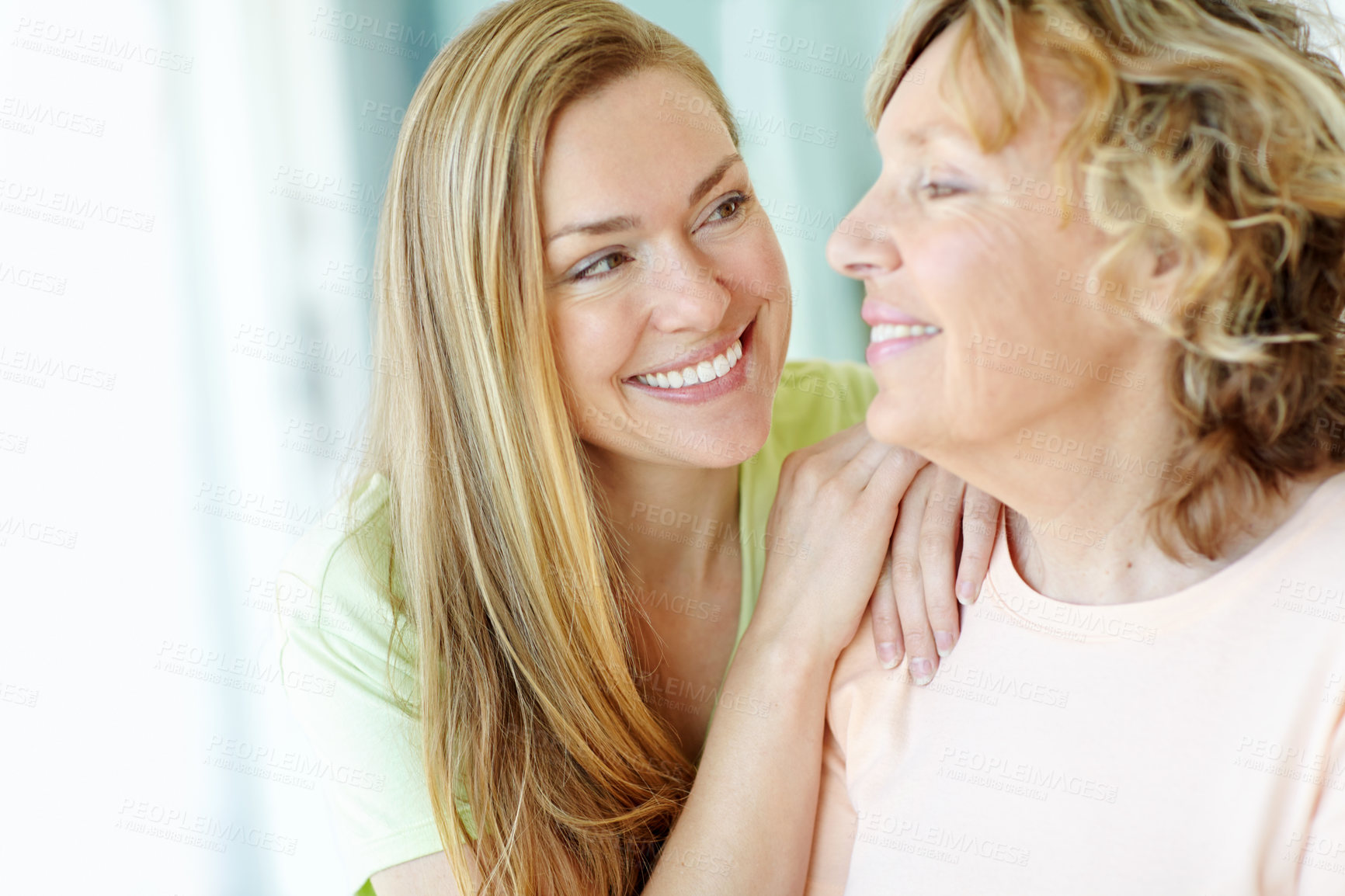 Buy stock photo Happy, bonding and woman with senior mother in home for family, connection and fun together. Smile, relax and female person hug elderly mom with care, love and appreciation in living room at house.