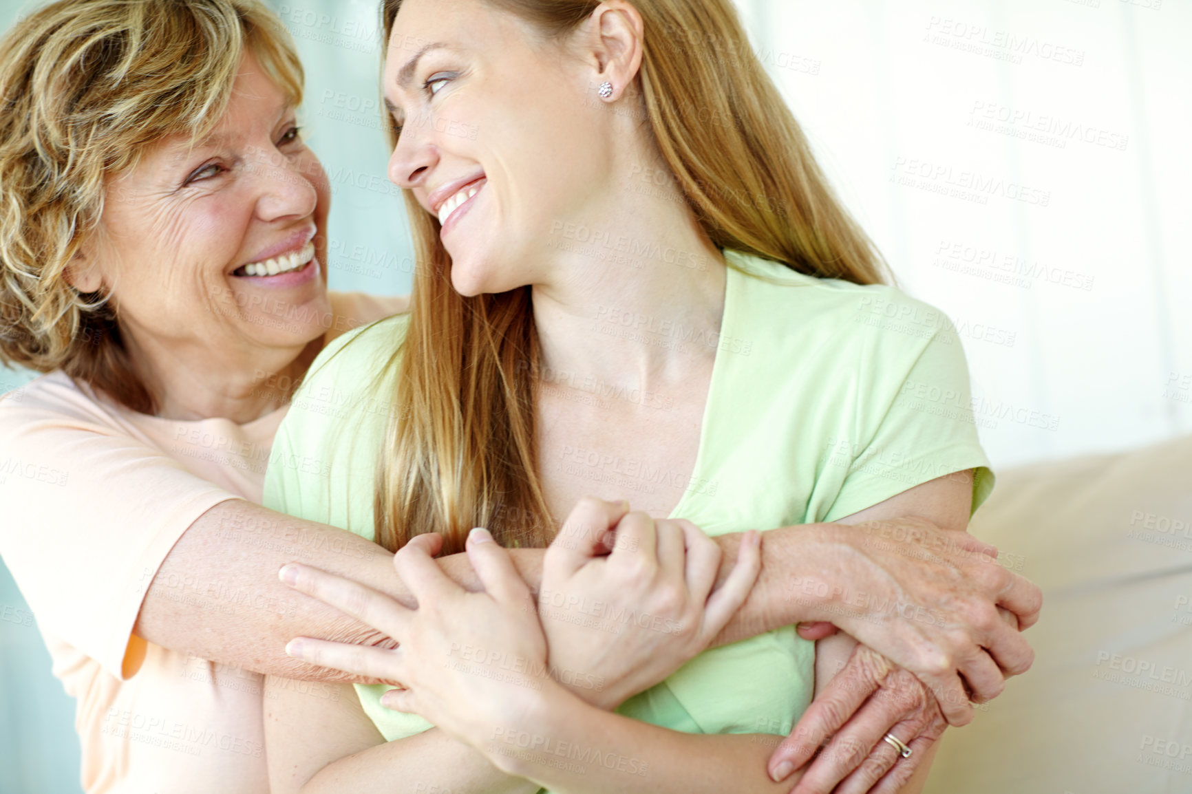 Buy stock photo Hug, mature mother and daughter on sofa with happy bonding, smile and morning care in living room together. Relax, senior mom and girl embrace on couch with love, support and gratitude in family home