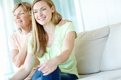 Buy stock photo Smile, mature mother and daughter on sofa with morning bonding, thinking and embrace in living room together. Relax, senior mom and girl on couch with love, care and support in happy family home