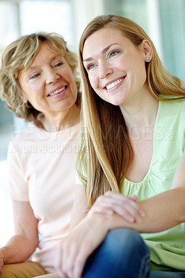 Buy stock photo Happy, mature mother and daughter in home with morning bonding, smile and care on couch in living room together. Relax, senior mom and girl on sofa with love, thinking and family support in apartment