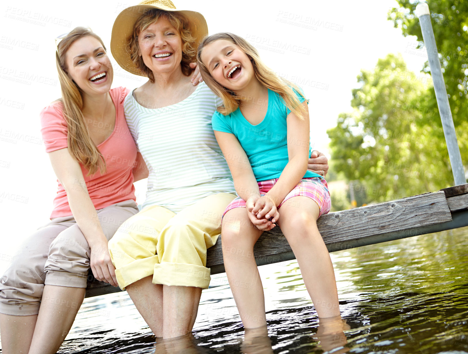 Buy stock photo Portrait, lake and grandmother with girl, generations and vacation with water, happiness and deck. Face, family and parent with weekend break, bonding together and love with summer holiday and laugh