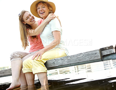 Buy stock photo Lake, senior mother and daughter with laughing for love, support and relax in Germany. People, parent and happiness  outdoor on water dam sky for holiday, break and nature for bonding and respect