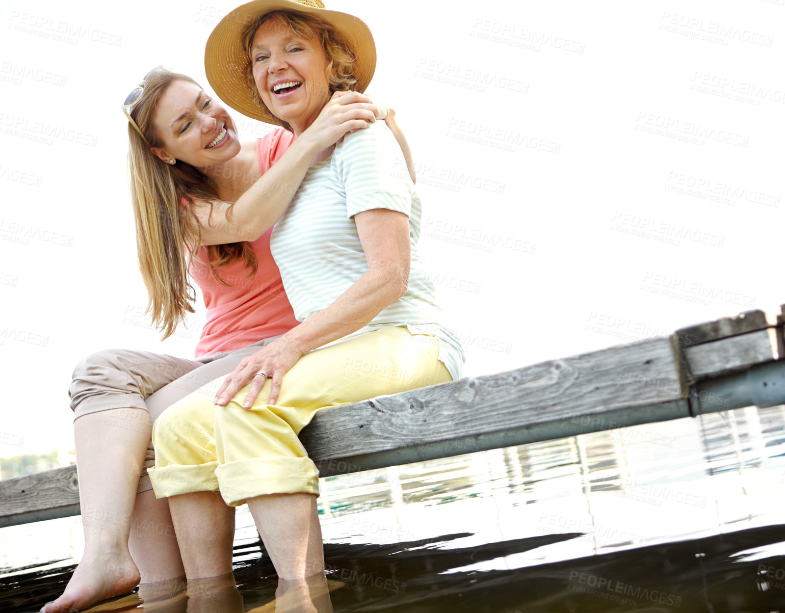 Buy stock photo Lake, senior mother and daughter with laughing for love, support and relax in Germany. People, parent and happiness  outdoor on water dam sky for holiday, break and nature for bonding and respect