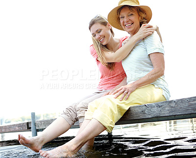 Buy stock photo Lake, senior mom and daughter with smile for love, support and relax in Germany. People, parent and outdoor with happiness on water dam sky for holiday, break and nature for bonding and respect