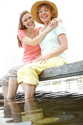 Buy stock photo Lake, senior mom and daughter on portrait for love, support and relax in Germany. People, parent and outdoor with happiness or smile on water dam for holiday, break and nature for bonding and respect