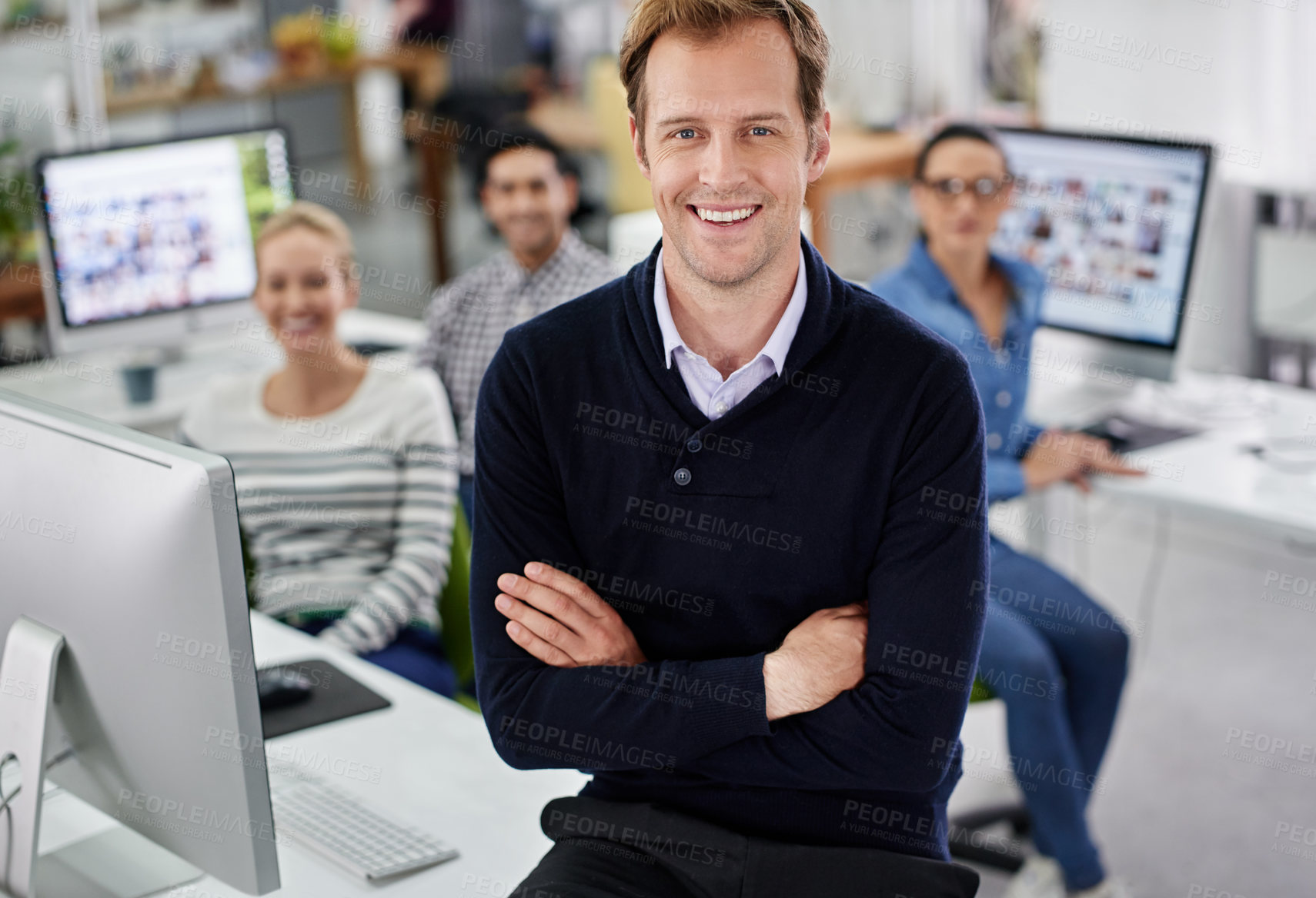 Buy stock photo Cropped portrait of a smiling businessman with his colleagues in the background