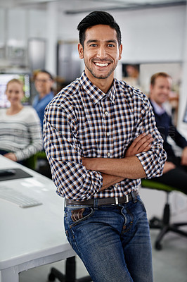 Buy stock photo Portrait of a laughing businessman with his colleagues in the background