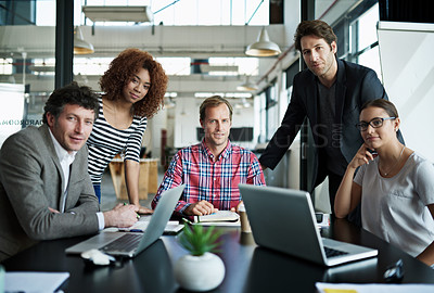 Buy stock photo Portrait of a group of smiling office workers sitting around a table