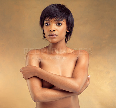 Buy stock photo Studio portrait of a beautiful shirtless young woman against a brown background