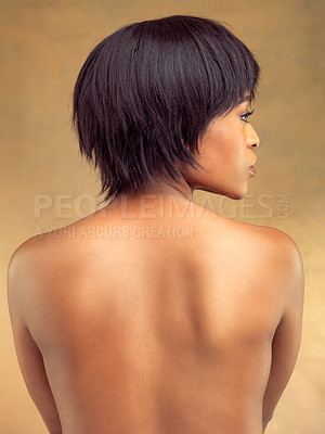 Buy stock photo Rearview studio shot of a beautiful young woman against a brown background