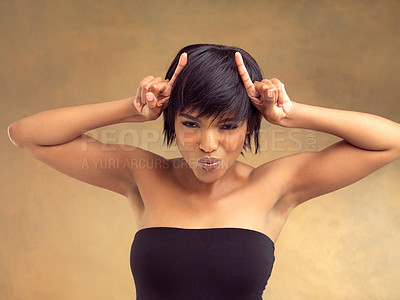 Buy stock photo Portrait, horns and fingers for black woman, studio and expression for comedy on background. Punk, smile and face of female model, funny and beauty for makeup and cosmetic with devil gesture