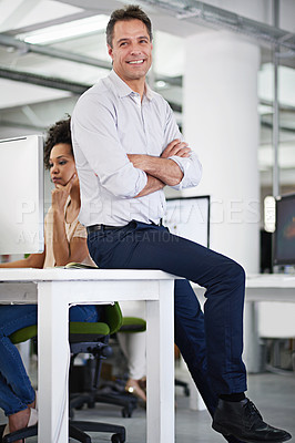 Buy stock photo Businessman, smile and table in portrait with arms crossed in office for job in workplace for startup. Male person, manager and happy on desk with technology in company with entrepreneur pride