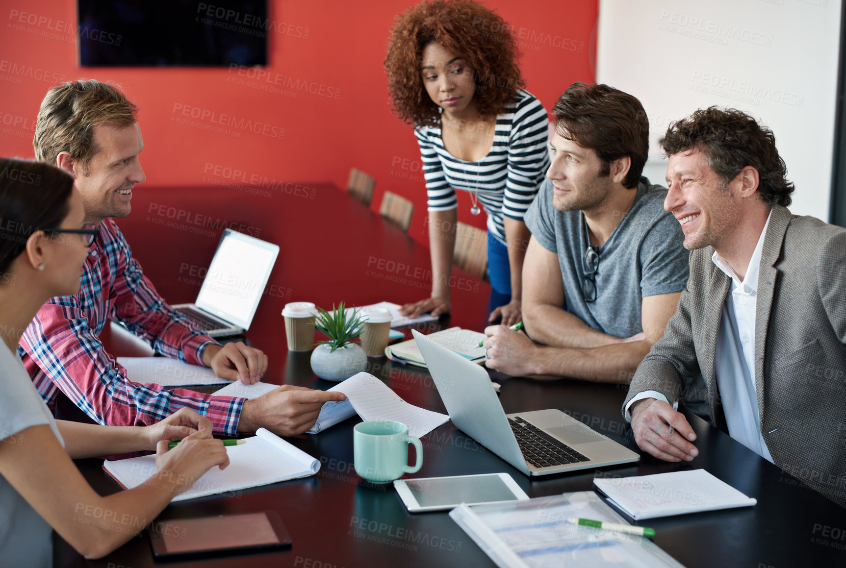 Buy stock photo Happy, business people and meeting with team or documents for planning, research or development at office. Group of young creative employees in collaboration or brainstorming for startup at workplace
