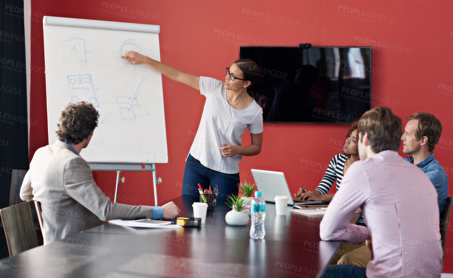 Buy stock photo Shot of a woman giving a presentation to a group of colleagues in a boardroom