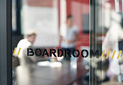 Buy stock photo Closeup shot of a sign on a boardroom window with businesspeople blurred in the background