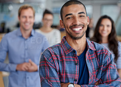 Buy stock photo Cropped portrait of positive young man with colleagues in the background