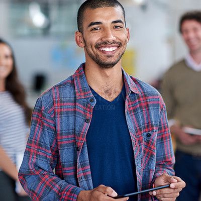 Buy stock photo Cropped portrait of a young man with colleagues in the background