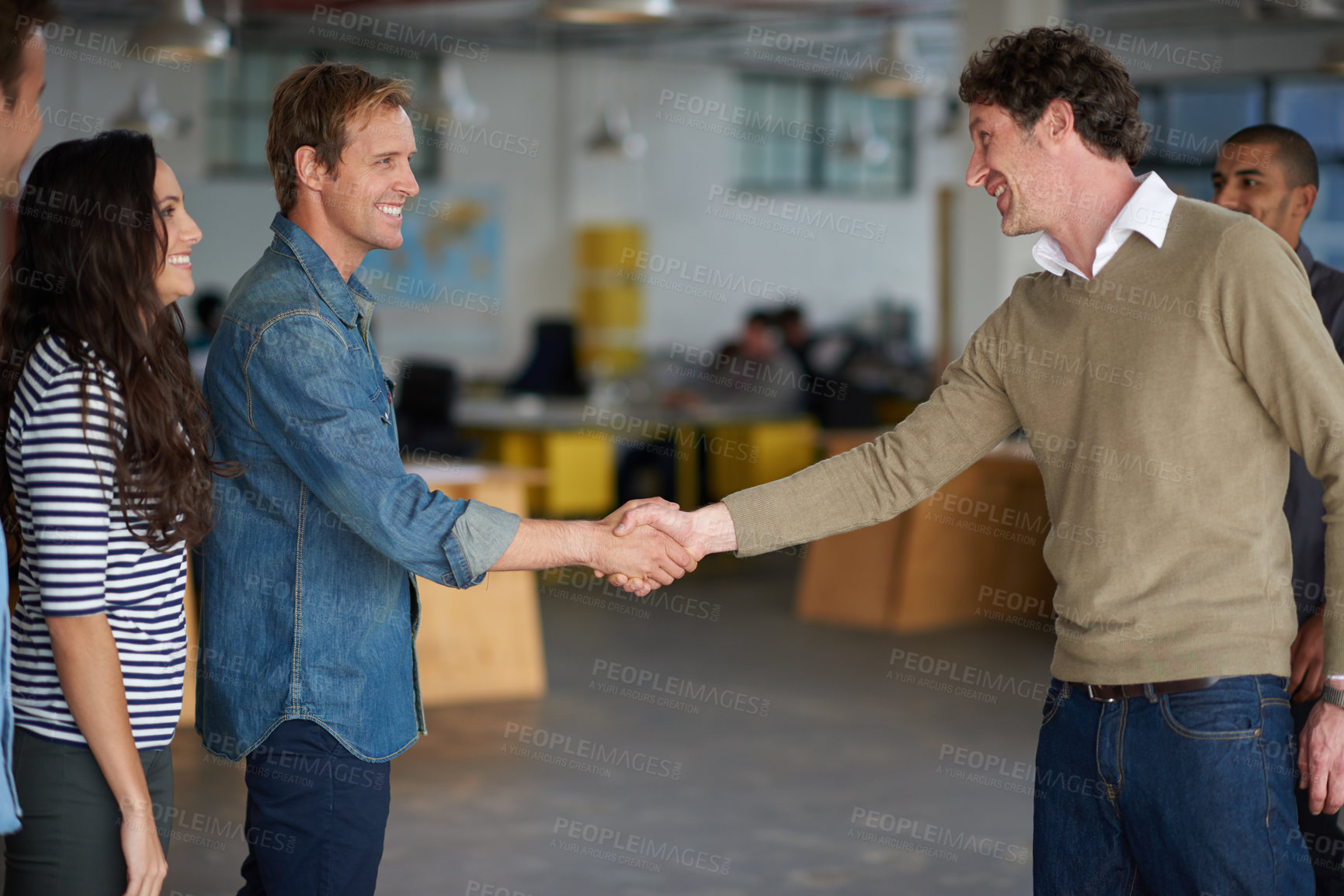 Buy stock photo Businessmen greeting each other with a handshake in an open office space