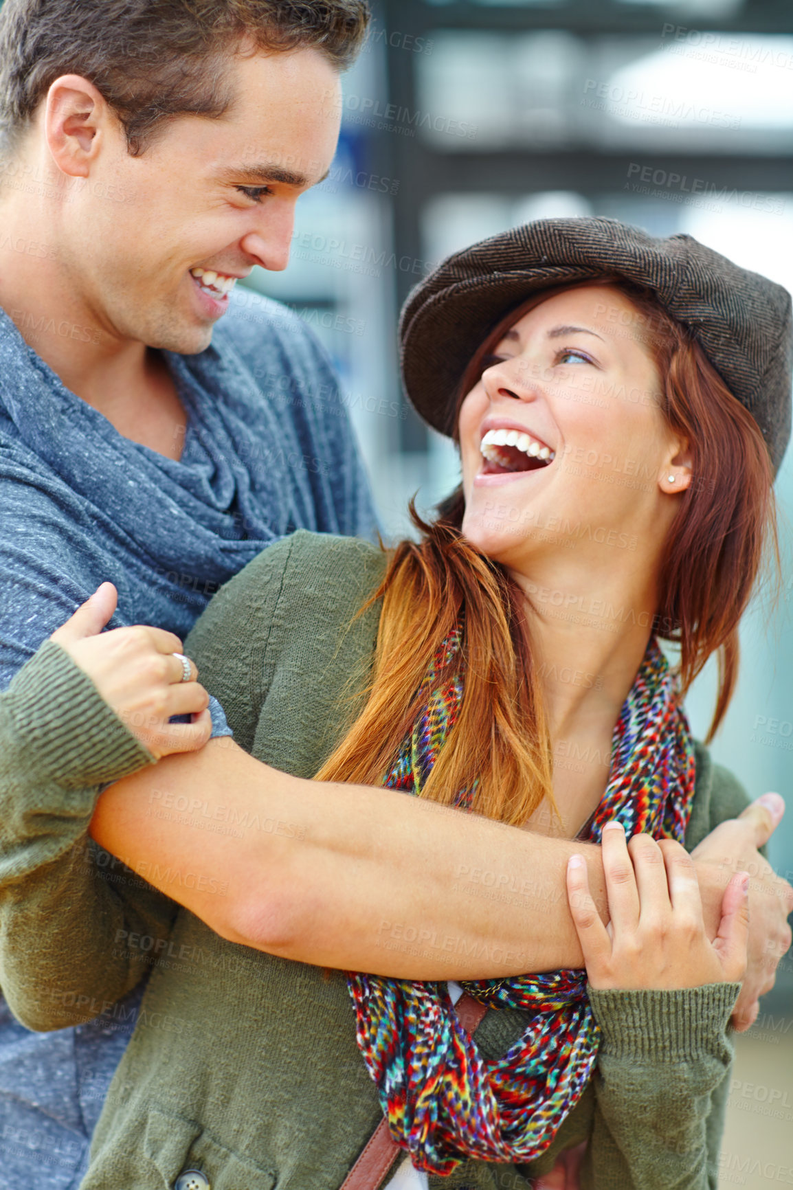 Buy stock photo Laugh, love and couple hug in city for support, care or connection for healthy relationship on holiday. Man, funny woman and embrace outdoor for romance, joke or talking to partner on date together