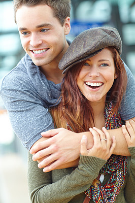 Buy stock photo A couple at a train station laughing together