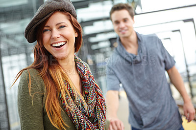 Buy stock photo Woman, smile and travel at train station for holiday, vacation or London journey. Couple, holding hands and girl with love, romance and laugh at funny joke with transport and adventure or tourism