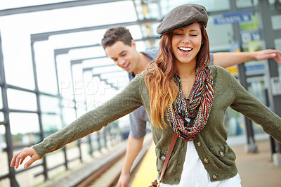 Buy stock photo Happy, couple and railway for travel at train station with freedom, subway and transport of morning journey. Smile, people and balance on platform for waiting, commute and metro delay of departure