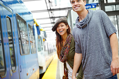 Buy stock photo Couple, romance and journey at train station for holiday, vacation or London adventure. Man, woman and holding hands with love, smile and laugh at funny joke with transport and travel or tourism