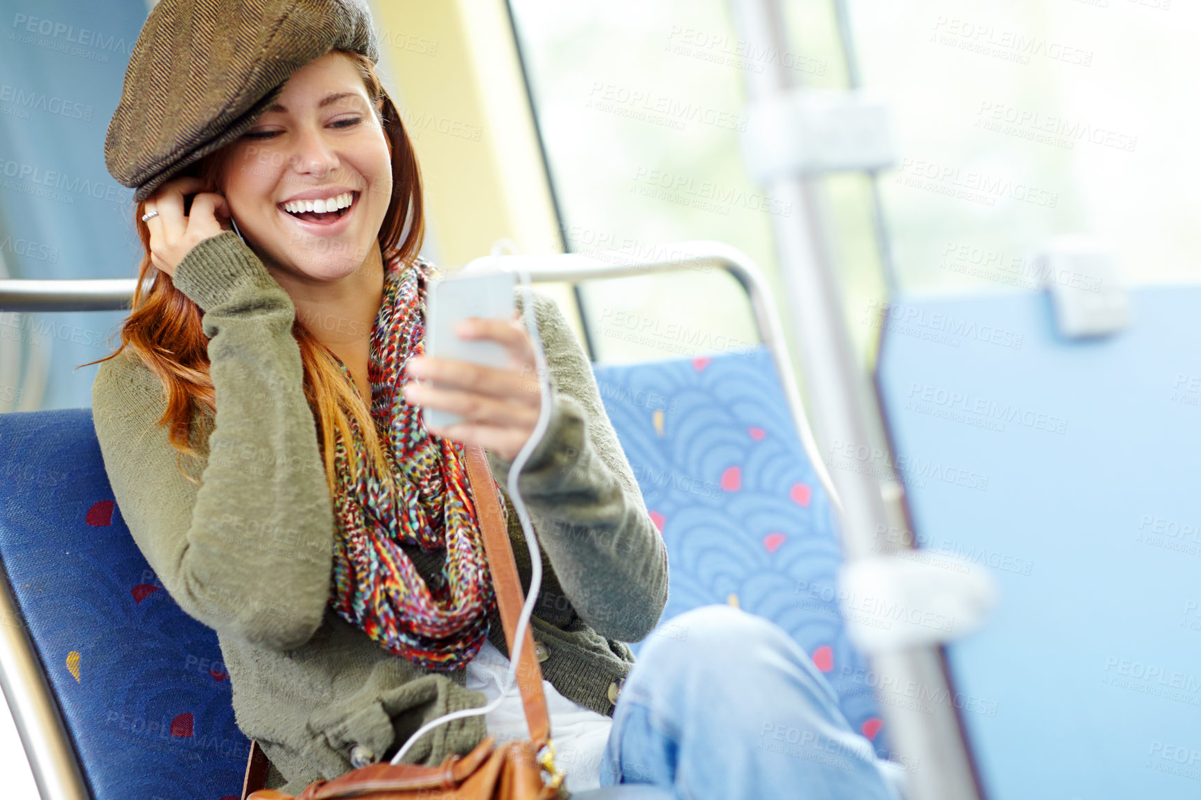 Buy stock photo Happy, train and woman with smartphone, listening to music and commute with humor, laughing and smile. Person, traveller and girl with cellphone, sound and audio laughing with podcast and connection