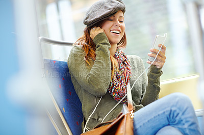 Buy stock photo Pretty girl on a train listening to her music on her phone with copyspace