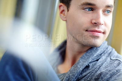 Buy stock photo Close up of an attractive male sitting on the train looking out the window