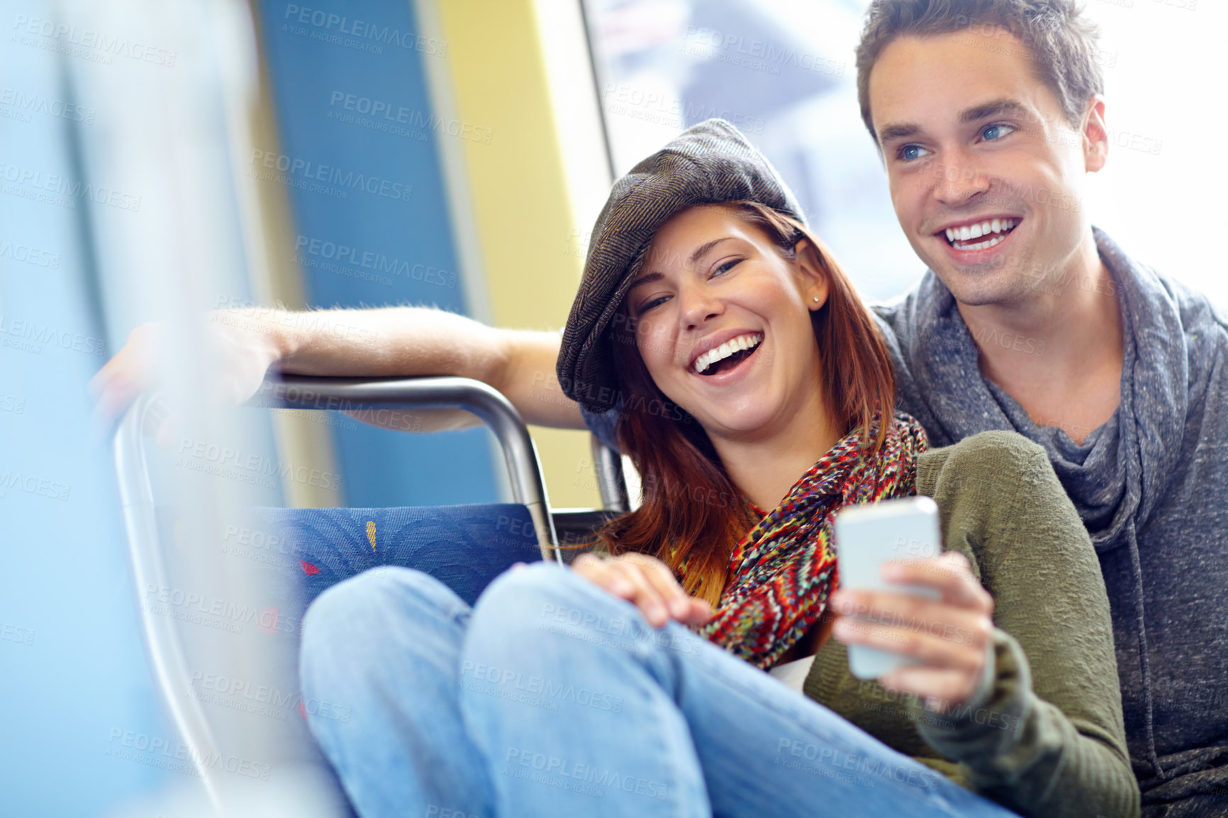 Buy stock photo Couple, phone and laughing on train for holiday, vacation or London honeymoon journey. Man, woman and online schedule for love, romance and happy with public transport and adventure or tourism