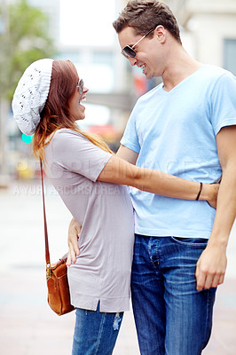 Buy stock photo A stylish couple embracing each other on the street