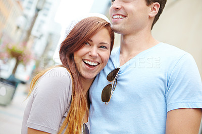Buy stock photo Portrait of a beautiful girl being embraced by her boyfriend on a city street