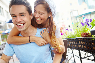 Buy stock photo A close couple laughing together while sitting at a coffee shop with copyspace
