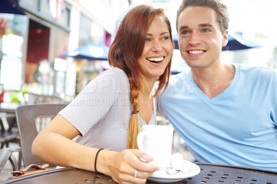 Buy stock photo A happy couple having a coffee at an outside cafe