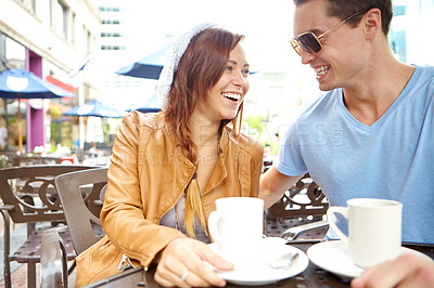 Buy stock photo A happy couple having coffee at an outside cafe with copyspace