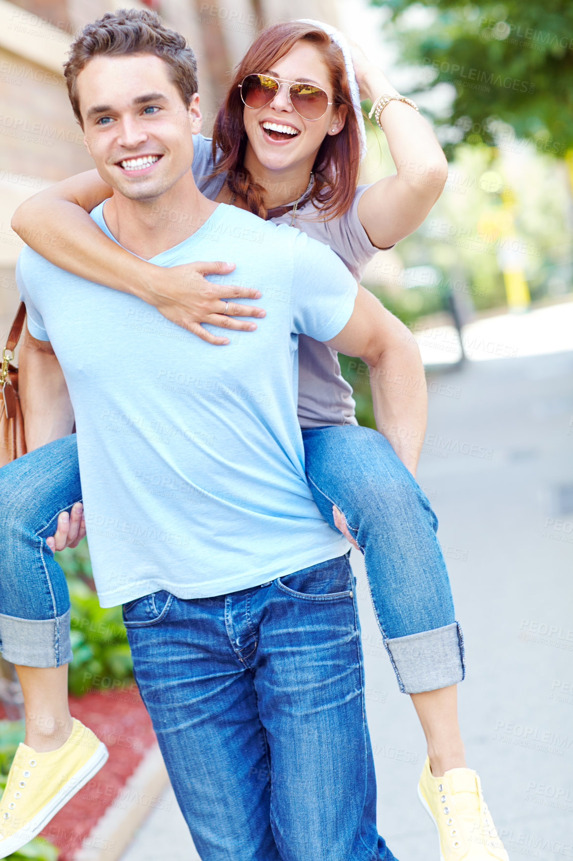 Buy stock photo Love, couple laughing and piggyback in city for connection, happiness and summer romance. Hug, man and carrying woman outdoor for funny relationship, support and travel with partner on date together