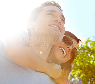 Buy stock photo Close up of  happy couple outside who are embracing with the sun behind them