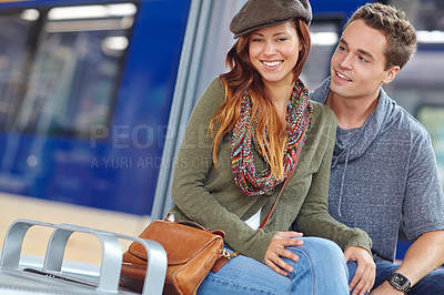 Buy stock photo Portrait of a happy couple sitting in a train station with copyspace