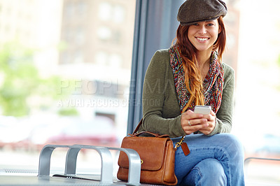 Buy stock photo Train station, portrait and woman with cellphone for waiting, patience and delay of public transport. Railway, female person and traveler with smile for mobile app, travel details and online booking