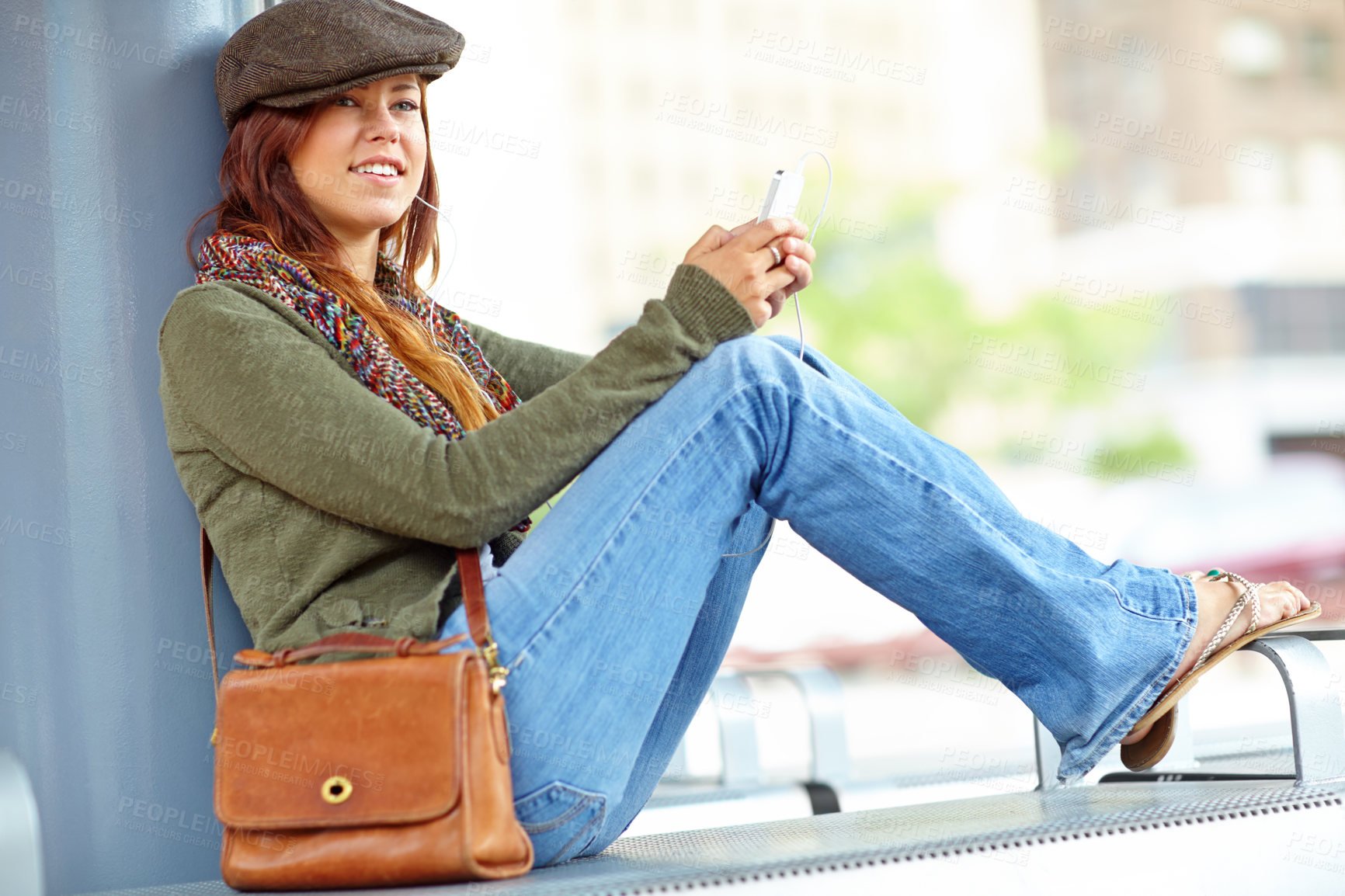 Buy stock photo Train station, woman and thinking on smartphone with earphones for streaming music and audio. Female person, outside and happy with texting on internet, social media and message for communication