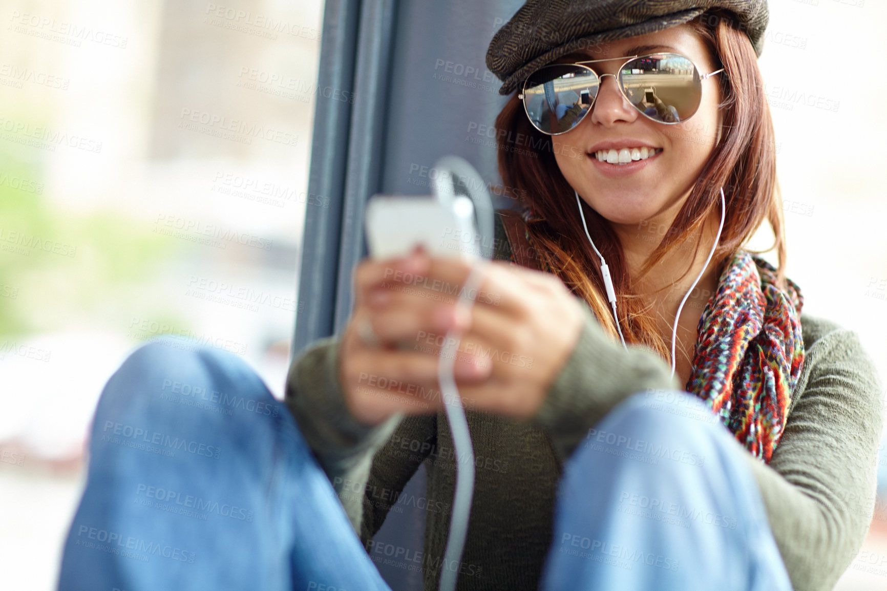 Buy stock photo Happy, train and woman with cellphone, listening to music and commute with sound, typing and smile. Person, traveller or girl with smartphone, mobile user or audio relaxing with podcast or connection