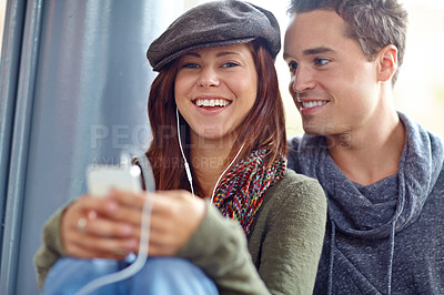 Buy stock photo Portrait of happy couple listening to music on their phone
