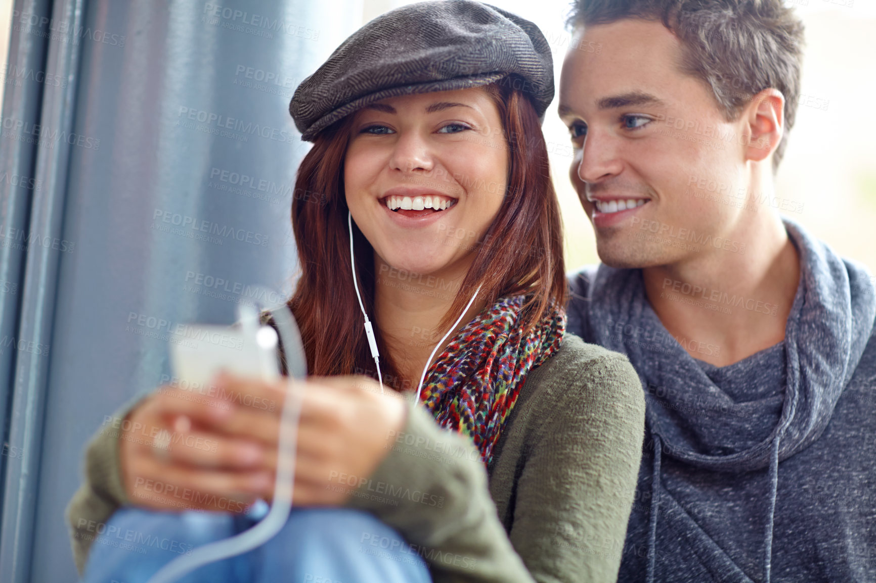 Buy stock photo Travel, music and love with couple at bus station for holiday,  streaming and journey together. Audio, public transportation and podcast with people at subway for support, adventure and date