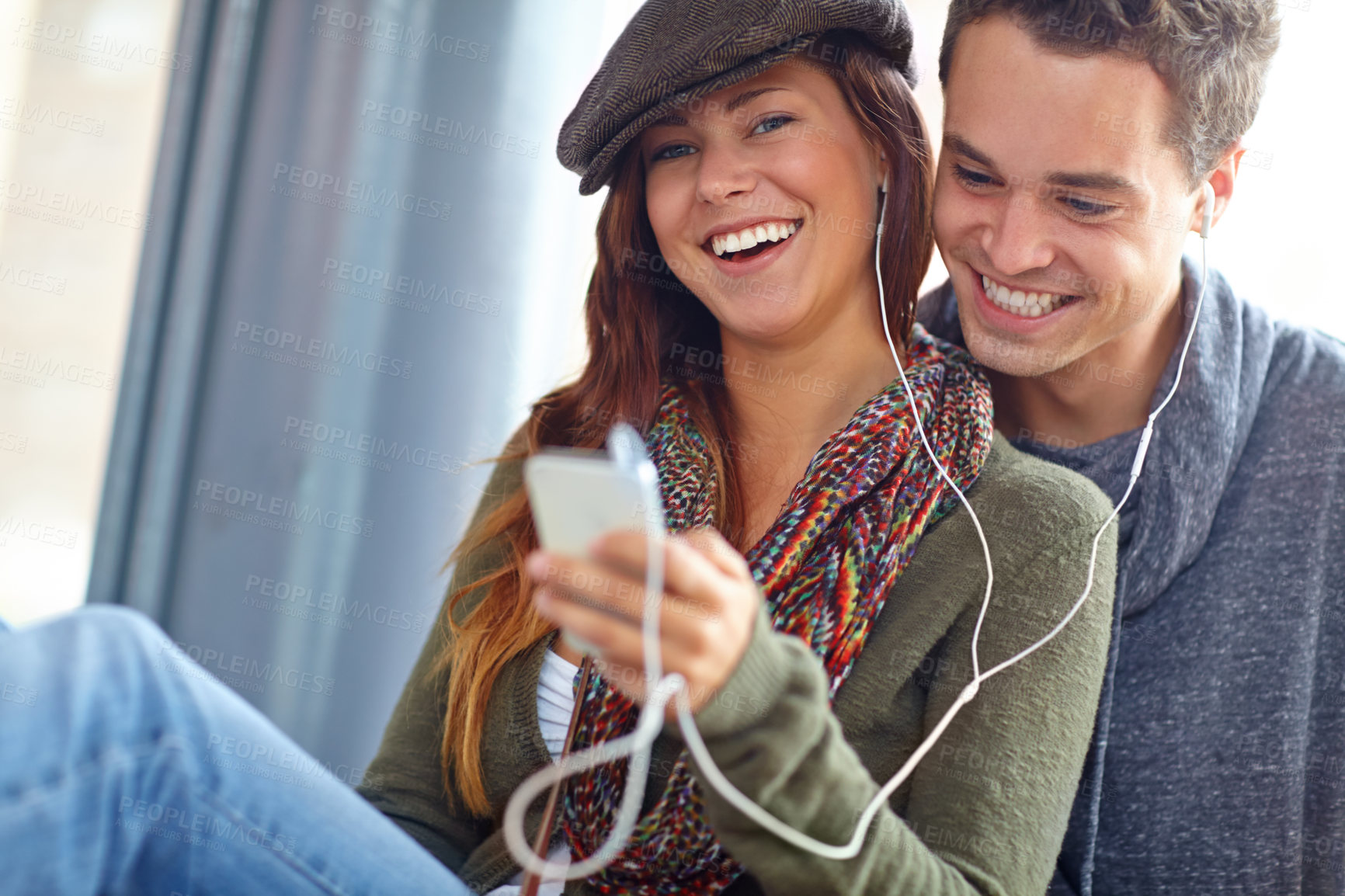 Buy stock photo Audio player, relax and love with couple and smile for holiday, streaming and playlist share together. Happiness, bonding and podcast with man and woman on date for sound, adventure and vacation