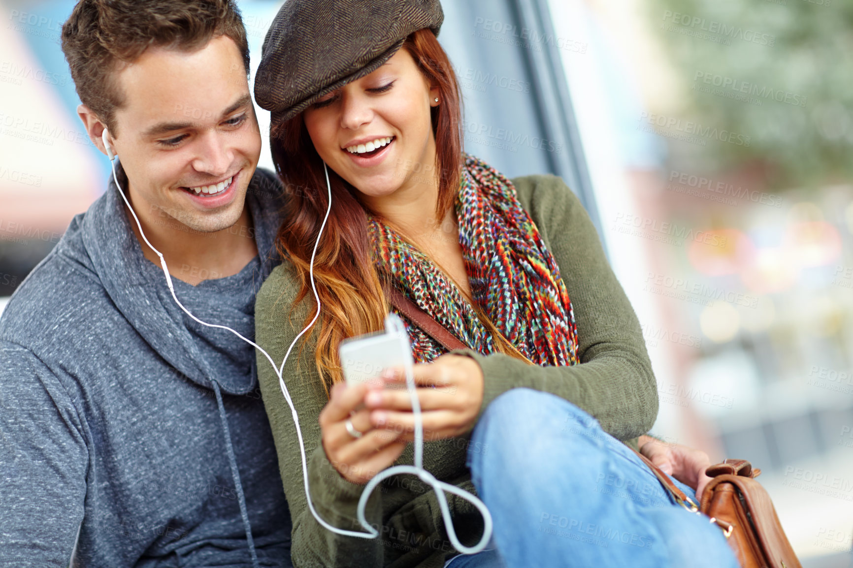 Buy stock photo Audio, music and smile with couple at bus station. for holiday, streaming and travel together. Journey, public transportation and podcast with people at subway for support, adventure and date