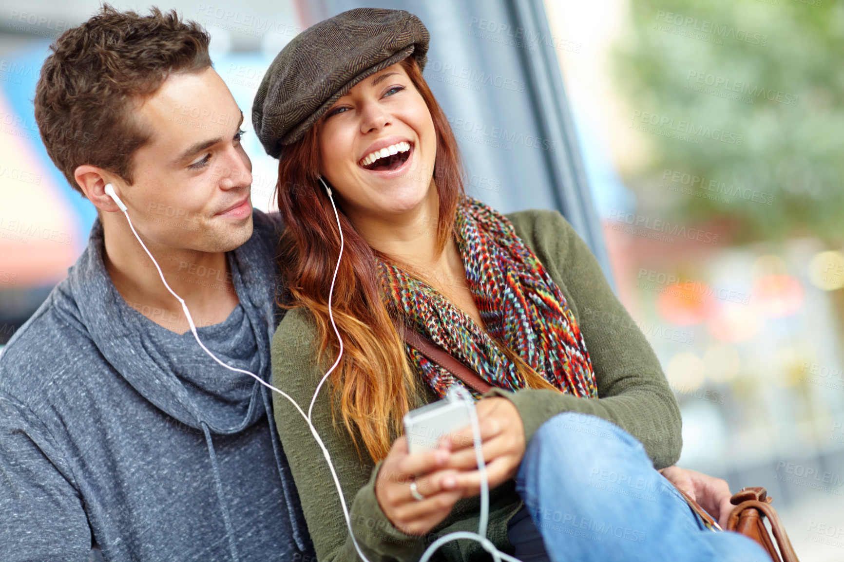 Buy stock photo Audio, music and funny with couple at bus station. for holiday, streaming and travel together. Journey, public transportation and podcast with people at subway for support, adventure and date