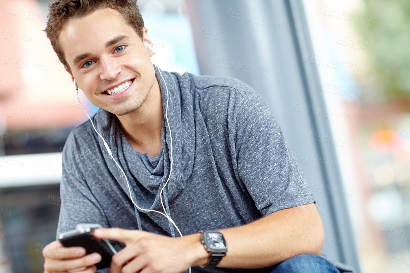 Buy stock photo Outdoor, man and happy on smartphone with earphones for streaming music and audio in England. Male person, portrait and smile with texting on internet, social media and message for communication