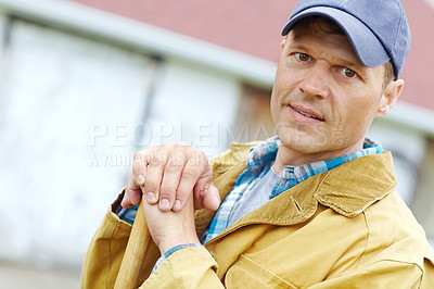 Buy stock photo Portrait of a man leaning on a gardening tool with copyspace