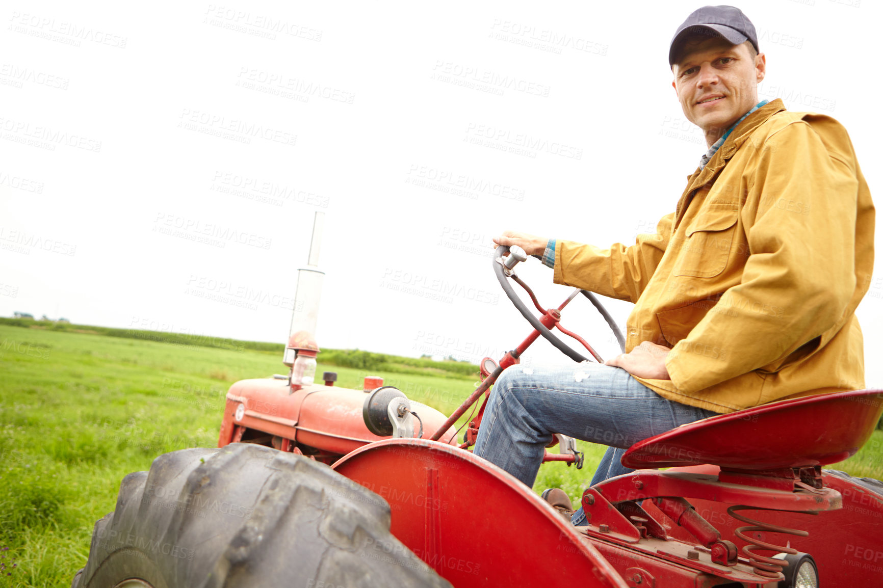 Buy stock photo Field, portrait and man with tractor for driving, harvesting and tiling for cultivation in countryside. Farming, male person or farmer with machine truck for agriculture, planting or growth by mockup